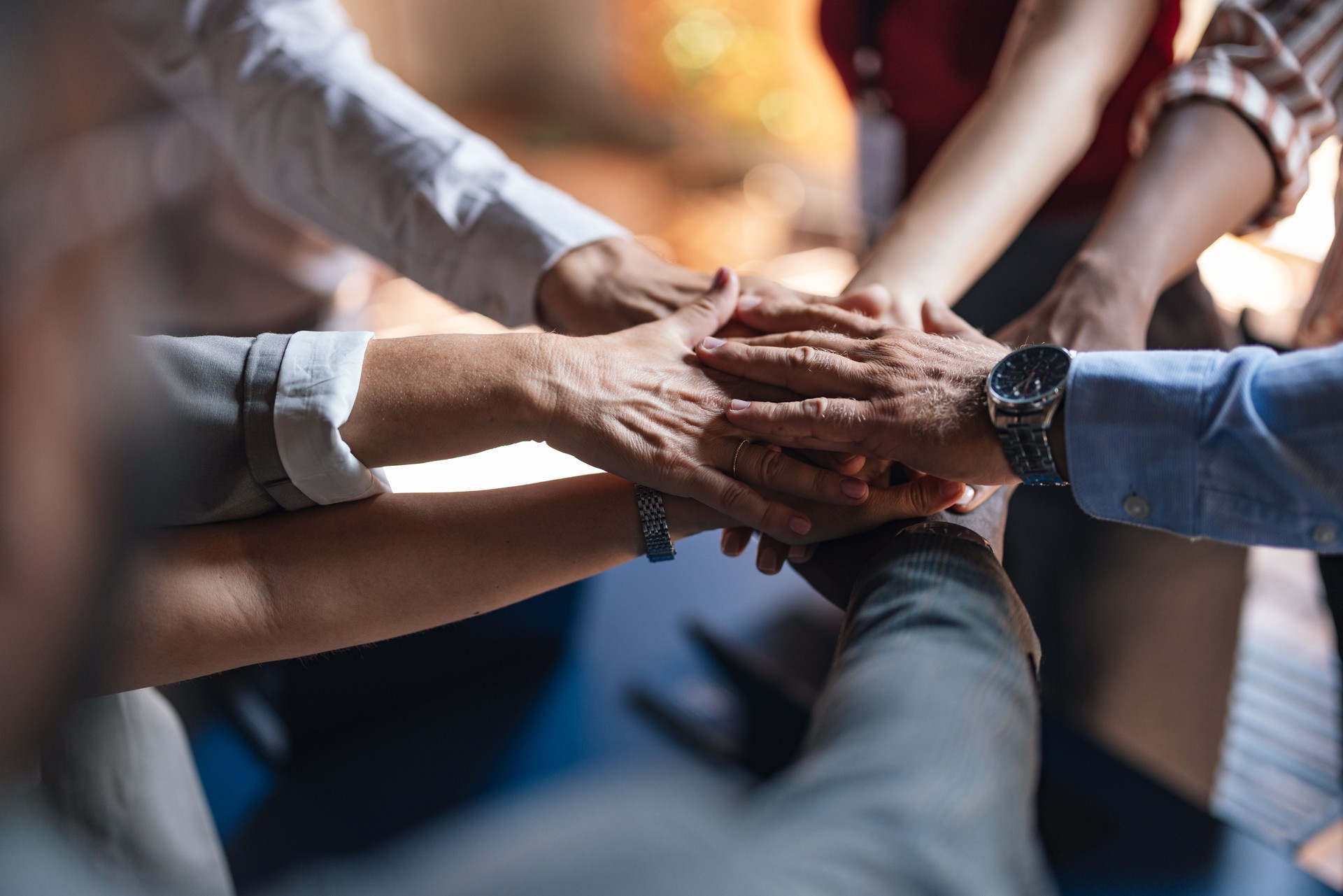 Teamwork and Unity Displayed Through Hands Overlapping in Group
